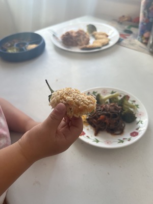 Baby holding a homemade jalapeño popper